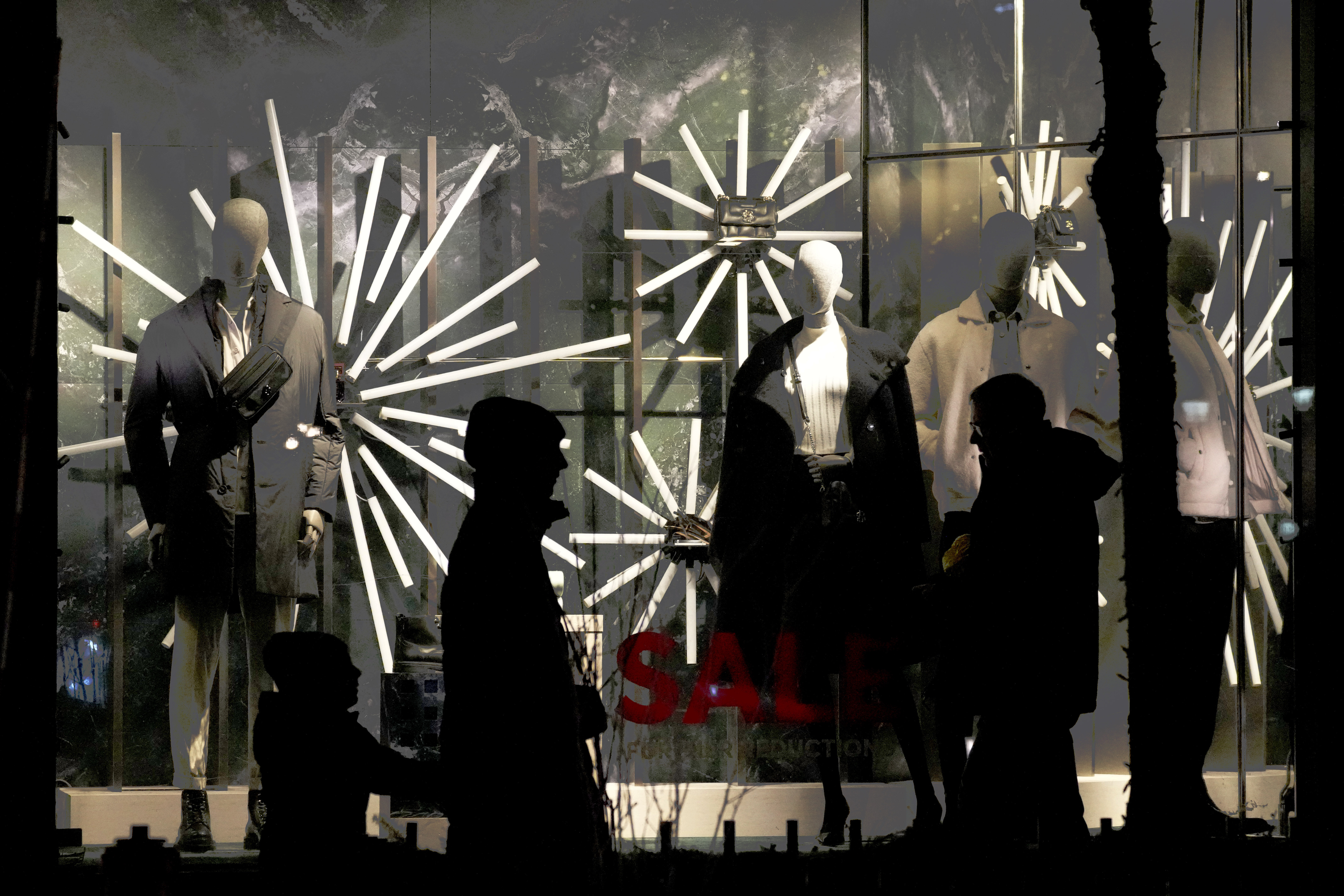 FILE - Shoppers walk on the Michigan Avenue in downtown Chicago, Dec. 15, 2024. (AP Photo/Nam Y. Huh, File)