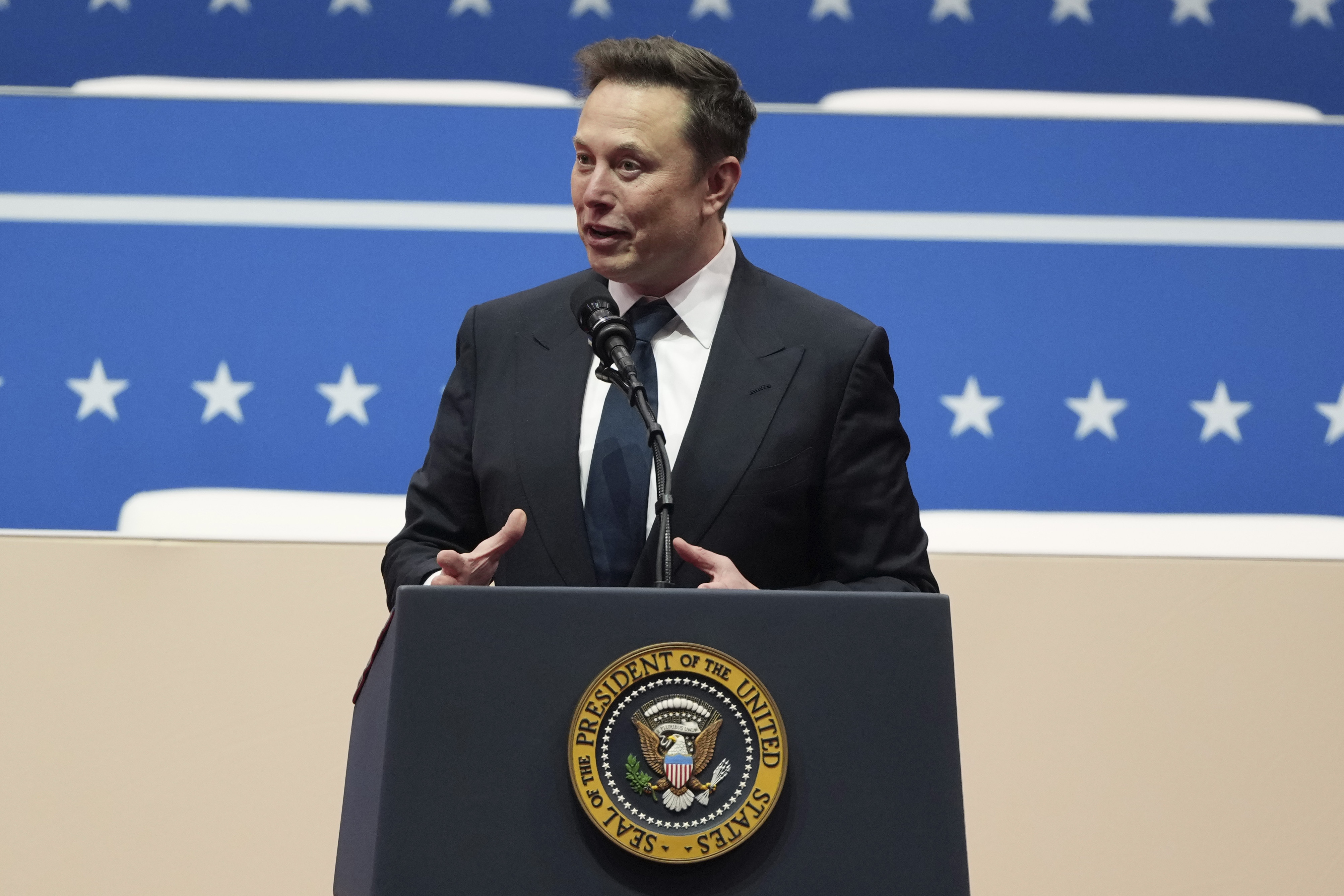 Elon Musk speaks at an indoor Presidential Inauguration parade event in Washington, Monday, Jan. 20, 2025. (AP Photo/Matt Rourke)