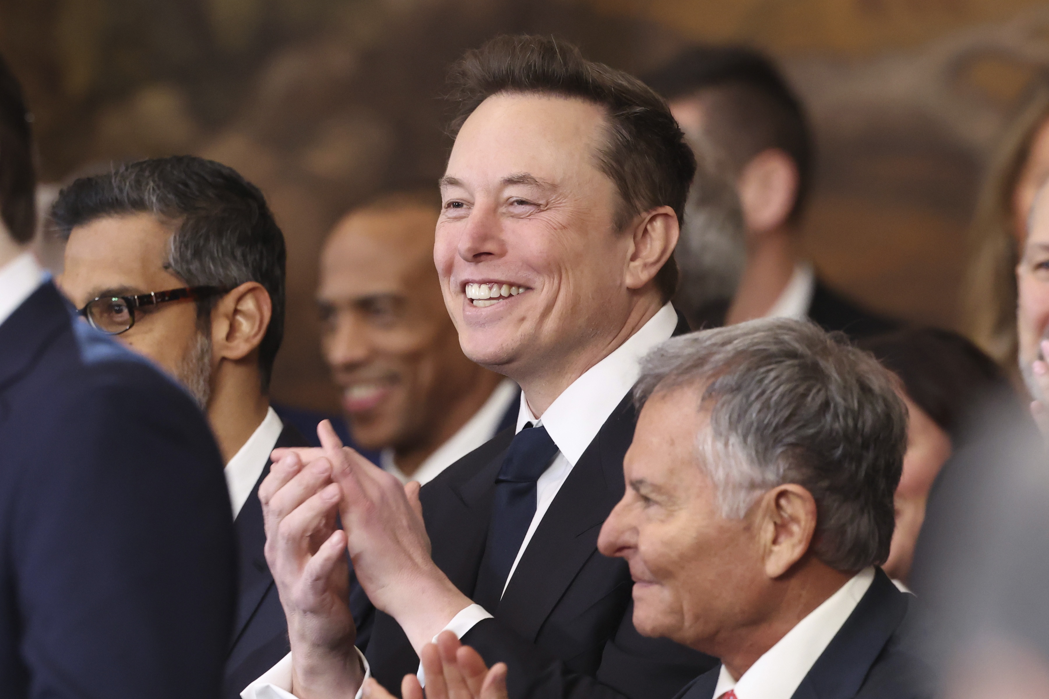 Elon Musk listens as President Donald Trump speaks after taking the oath of office at the 60th Presidential Inauguration in the Rotunda of the U.S. Capitol in Washington, Monday, Jan. 20, 2025. (Kevin Lamarque/Pool Photo via AP)