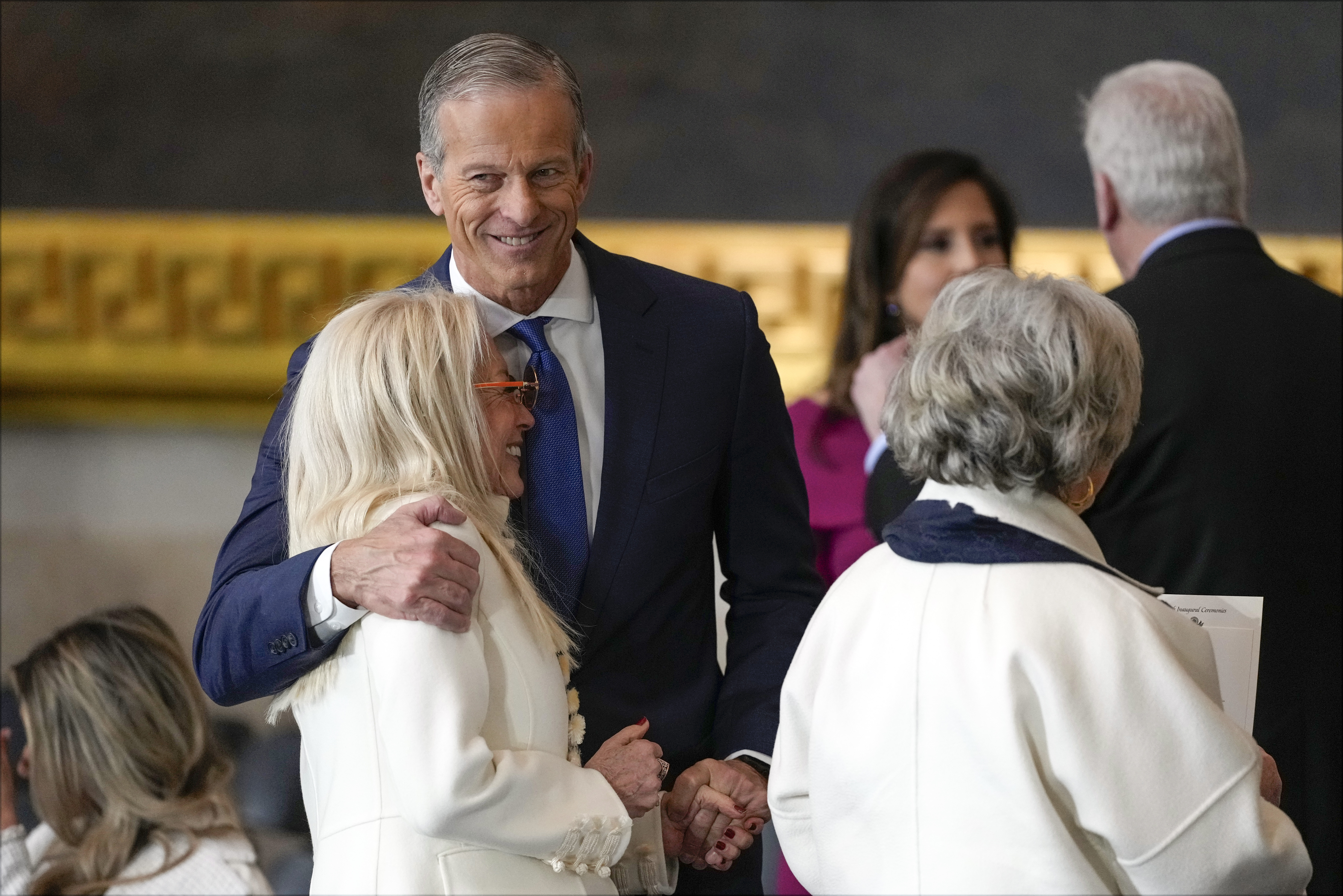 Senate Majority Leader John Thune, R-S.D., hugs Miriam Adelson before the 60th Presidential Inauguration in the Rotunda of the U.S. Capitol in Washington, Monday, Jan. 20, 2025. (AP Photo/Julia Demaree Nikhinson, Pool)