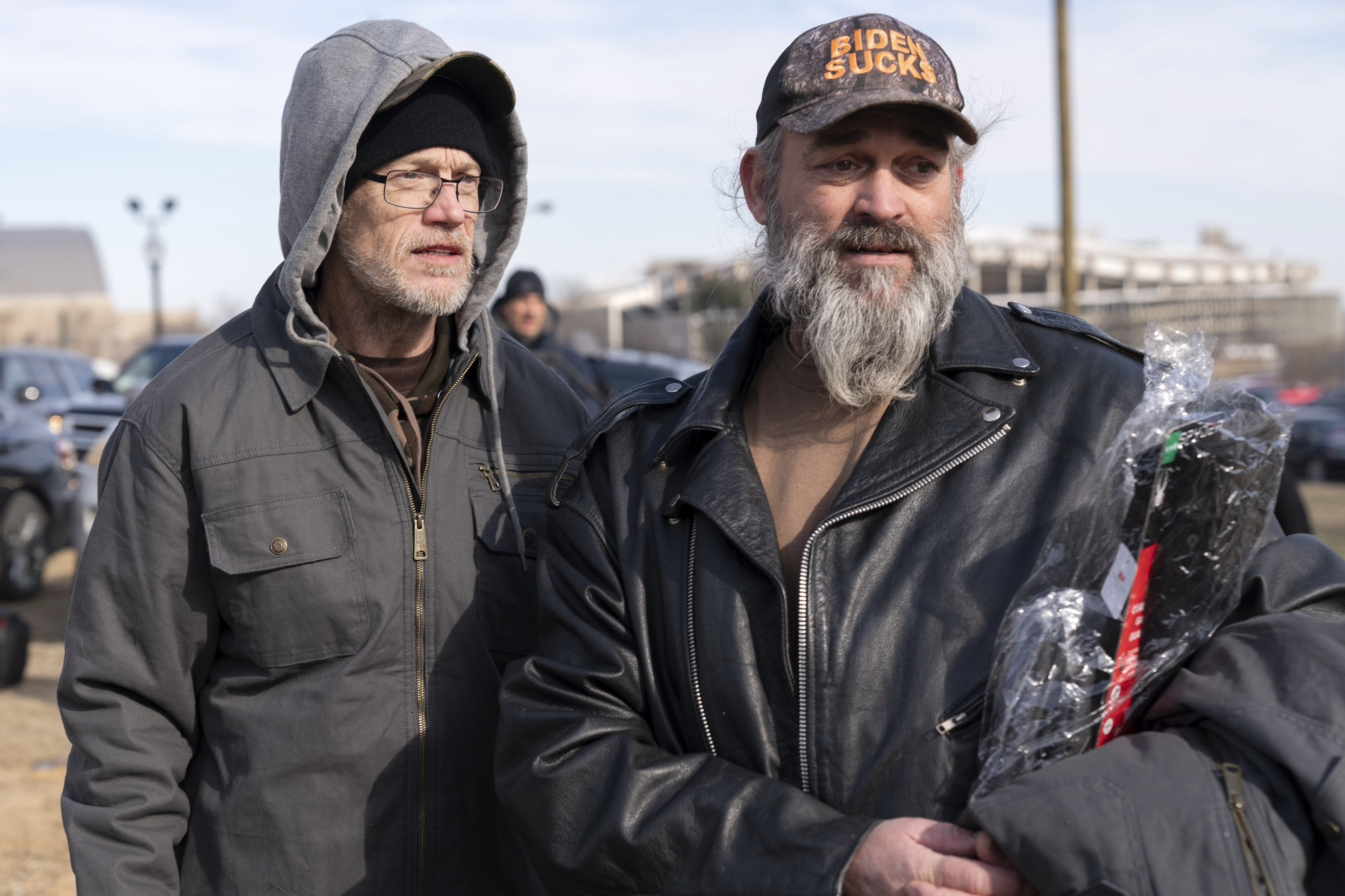 Supporters of President Donald Trump, Kevin Loftus, left and William Sarsfield III, who were convicted for participating in the Jan. 6 riot at the U.S. Capitol, talk to reporters after being pardoned and released in the early morning hours from the Philadelphia Federal Detention Center before traveling to Washington, Tuesday, Jan. 21, 2025. (AP Photo/Jose Luis Magana)