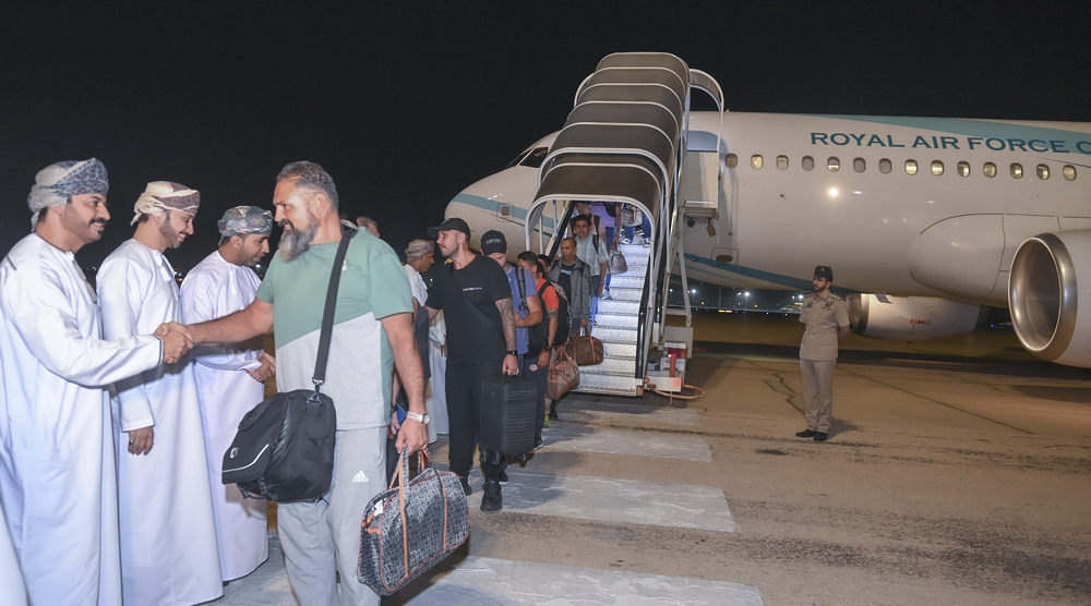 This image released by the state-run Oman News Agency show the crew of the Galaxy Leader arriving in Muscat, Oman, after being released by Yemen's Houthi rebels on Wednesday, Jan. 22, 2025. (Oman News Agency via AP)