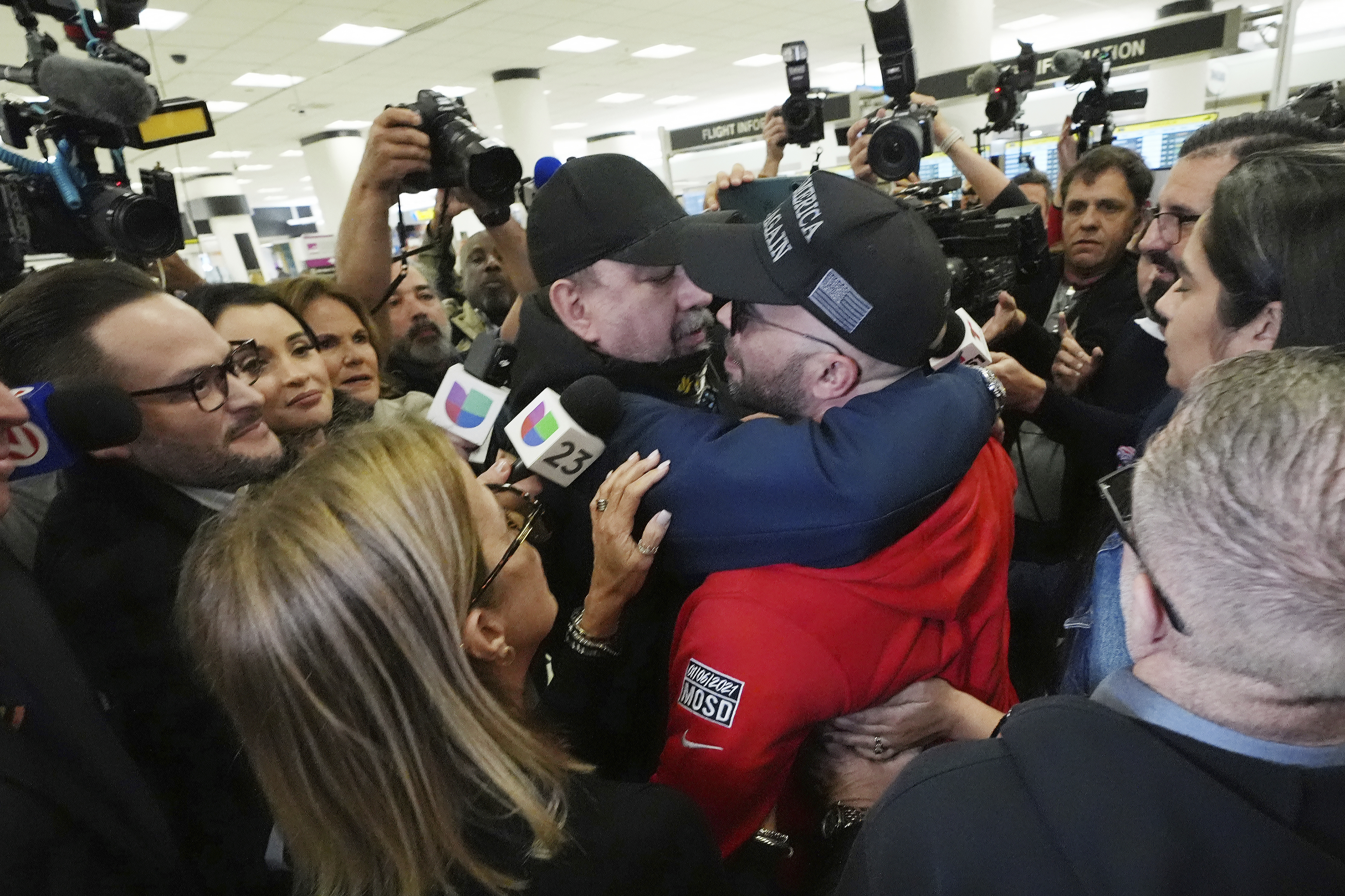 Enrique Tarrio, center right, is hugged by a supporter after arriving at Miami International Airport, Wednesday, Jan. 22, 2025, in Miami. Tarrio was pardoned by President Donald Trump after he was convicted of seditious conspiracy for his role in the January 6 attack on the U.S. Capitol. (AP Photo/Marta Lavandier)