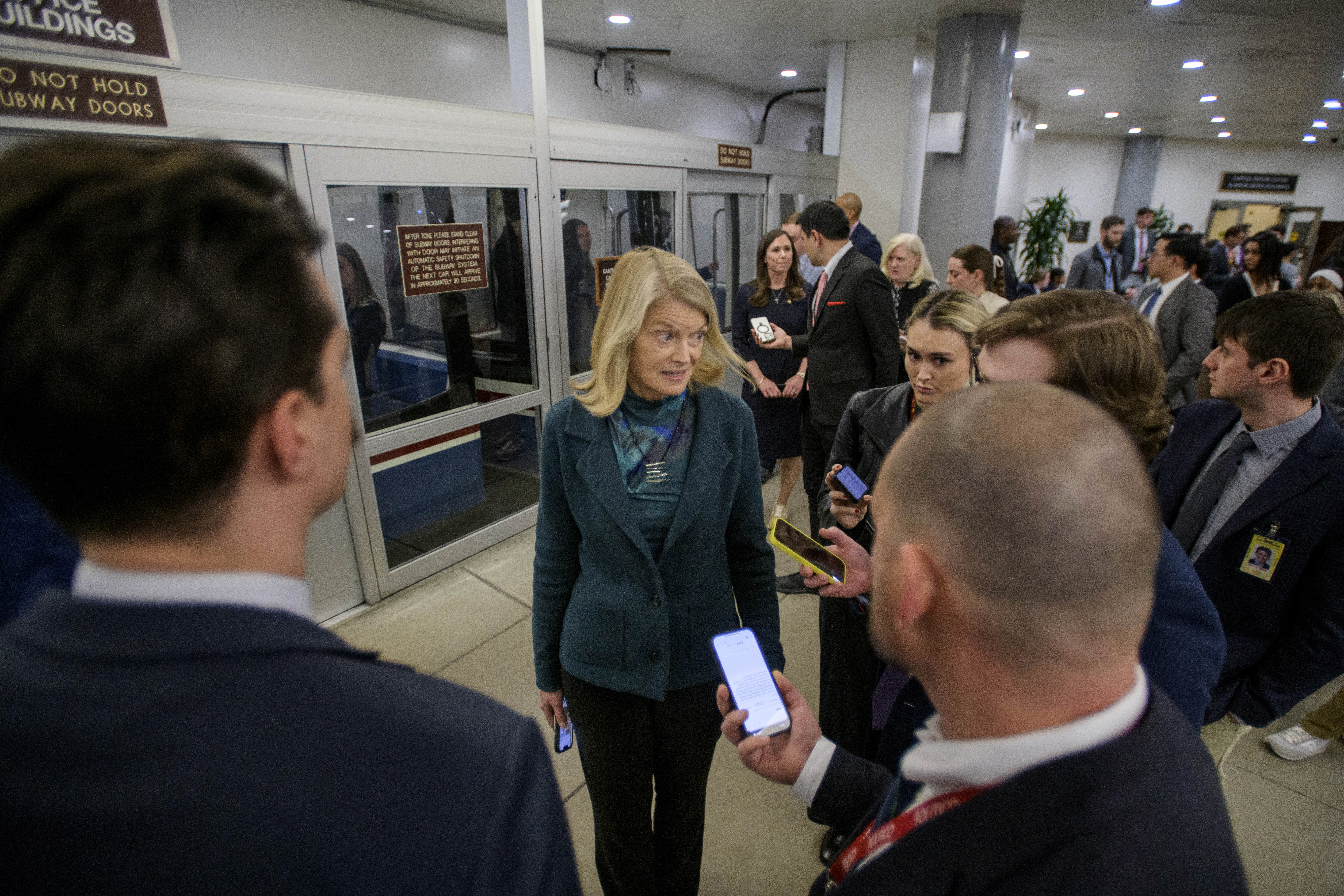 Sen. Lisa Murkowski, R-Alaska, talks with reporters as she makes her way through the Senate subway at the Capitol, Thursday, Jan. 23, 2025, in Washington. (AP Photo/Rod Lamkey, Jr.)