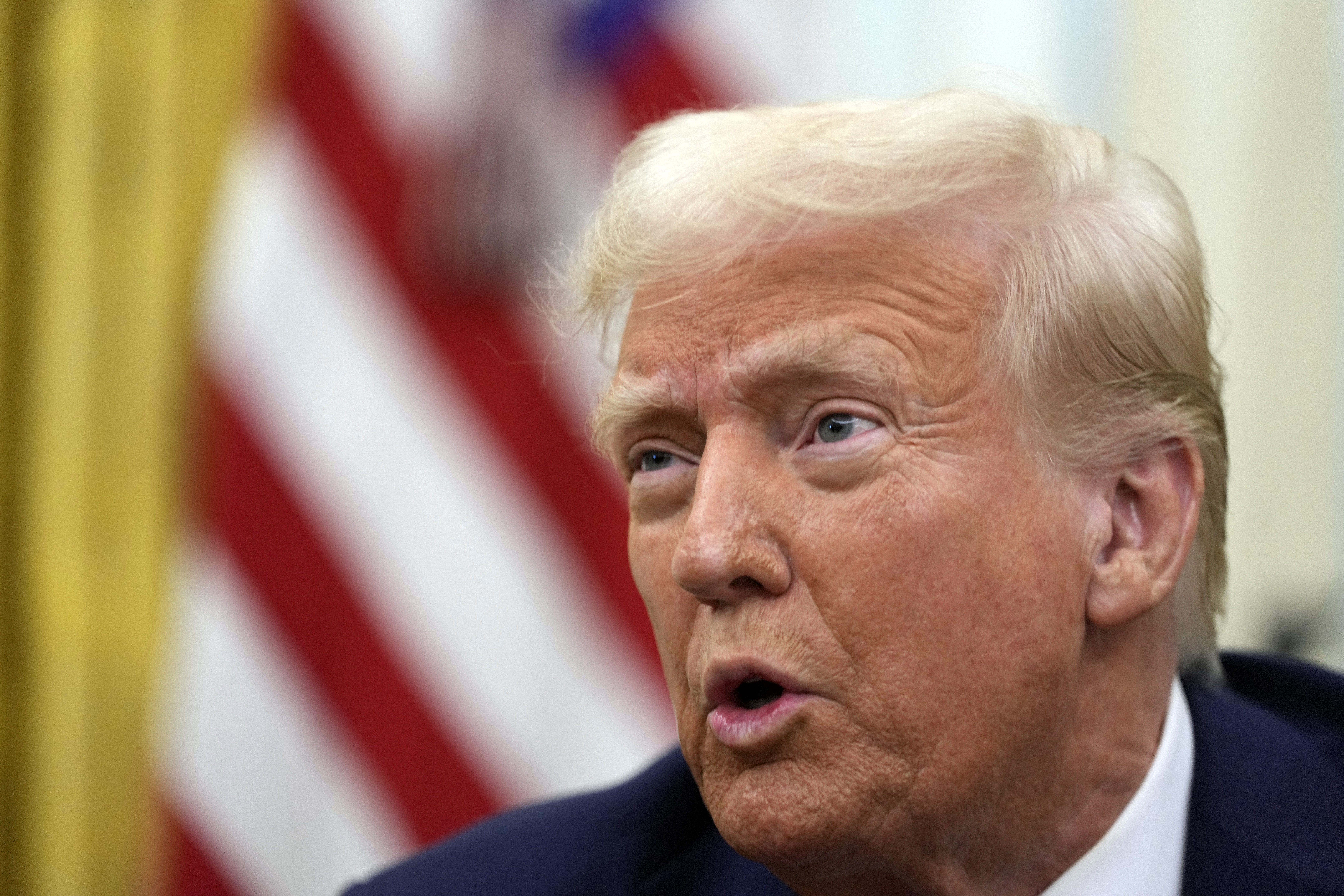 President Donald Trump speaks to reporters as he signs executive orders in the Oval Office of the White House, Thursday, Jan. 23, 2025, in Washington. (AP Photo/Ben Curtis)