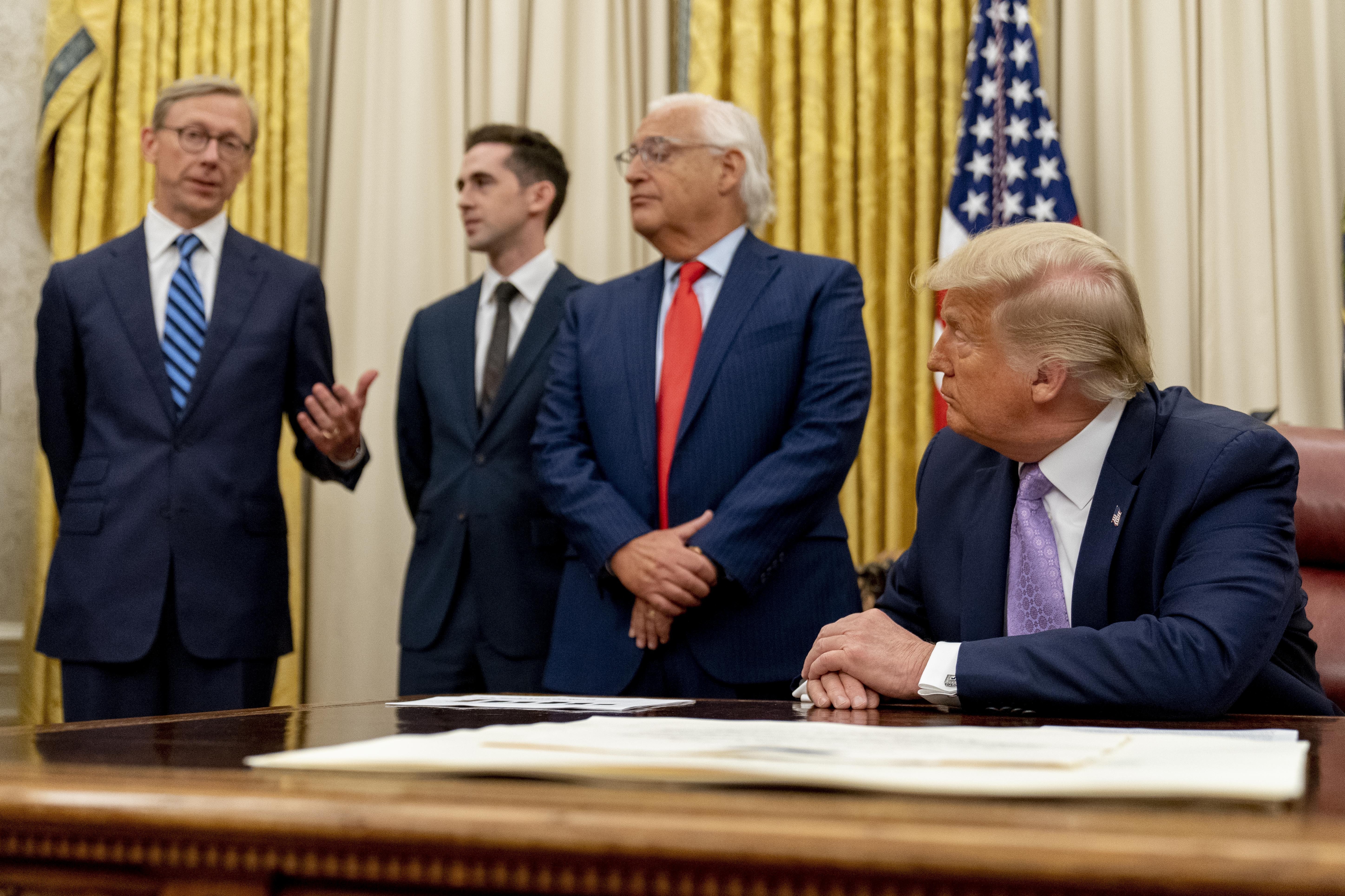 FILE - From left, U.S. special envoy for Iran Brian Hook, accompanied by from left, Avraham Berkowitz, Assistant to the President and Special Representative for International Negotiations, U.S. Ambassador to Israel David Friedman, and President Donald Trump, speaks in the Oval Office at the White House, Aug. 12, 2020, in Washington. (AP Photo/Andrew Harnik, File)