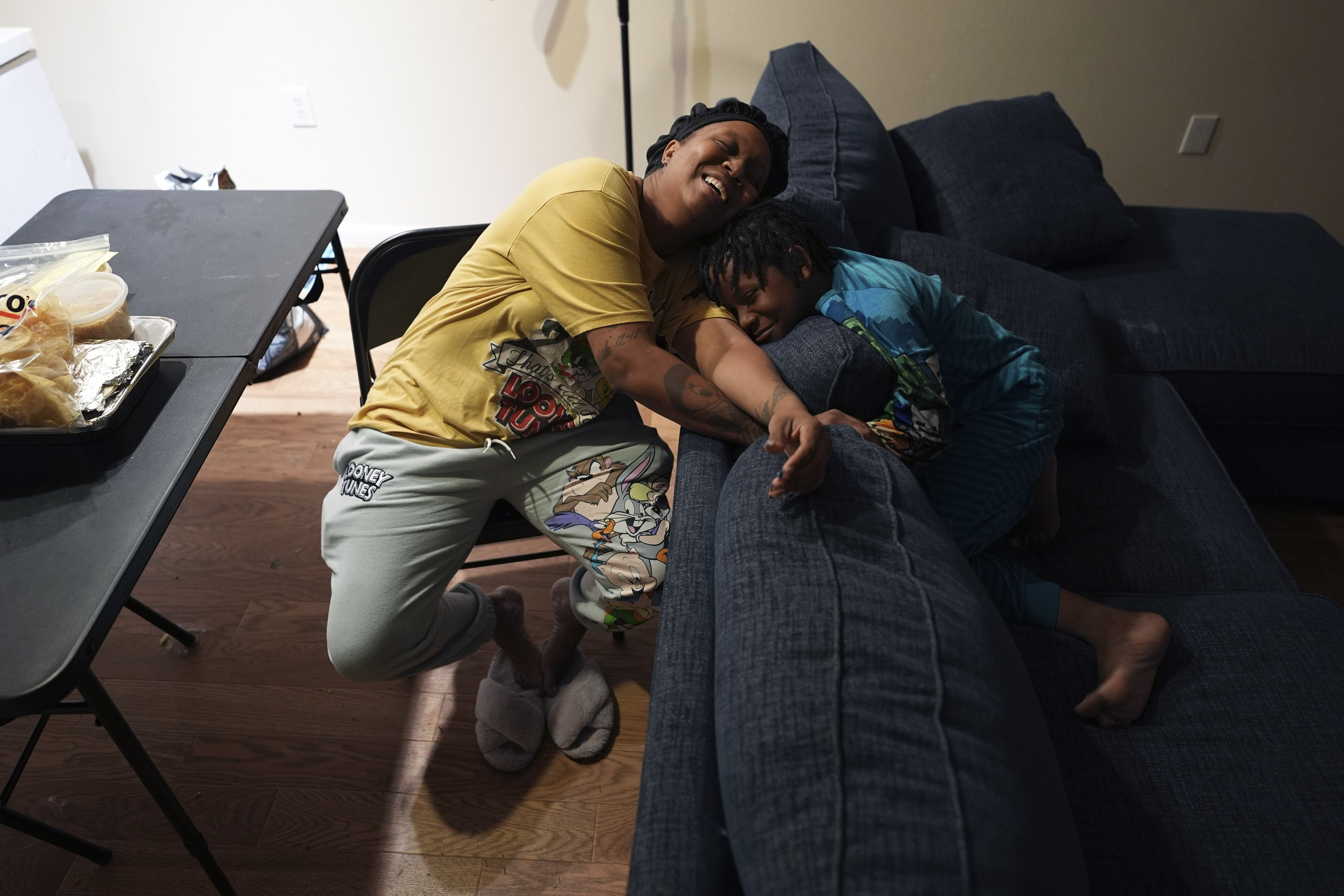 TiAnna Yeldell, left, spends time with her son Ivan, 8, right, at her home, Thursday, Nov. 14, 2024, in Missouri City, Texas. (AP Photo/Eric Gay)