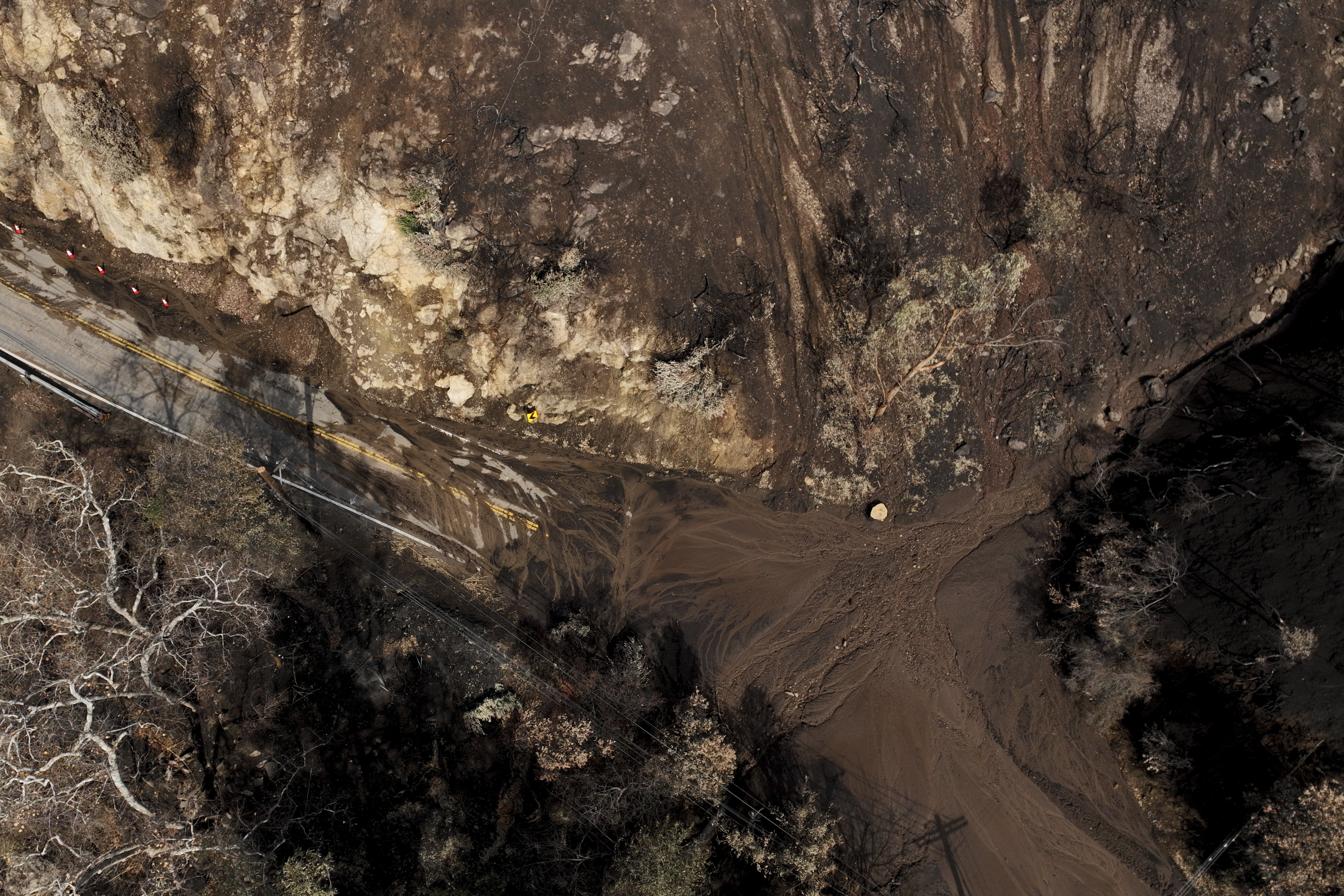 Mud covers Topanga Canyon Rd. on the Palisades Fire burn area after a series of weekend storms Monday, Jan. 27, 2025 near Malibu, Calif. (AP Photo/Jae C. Hong)