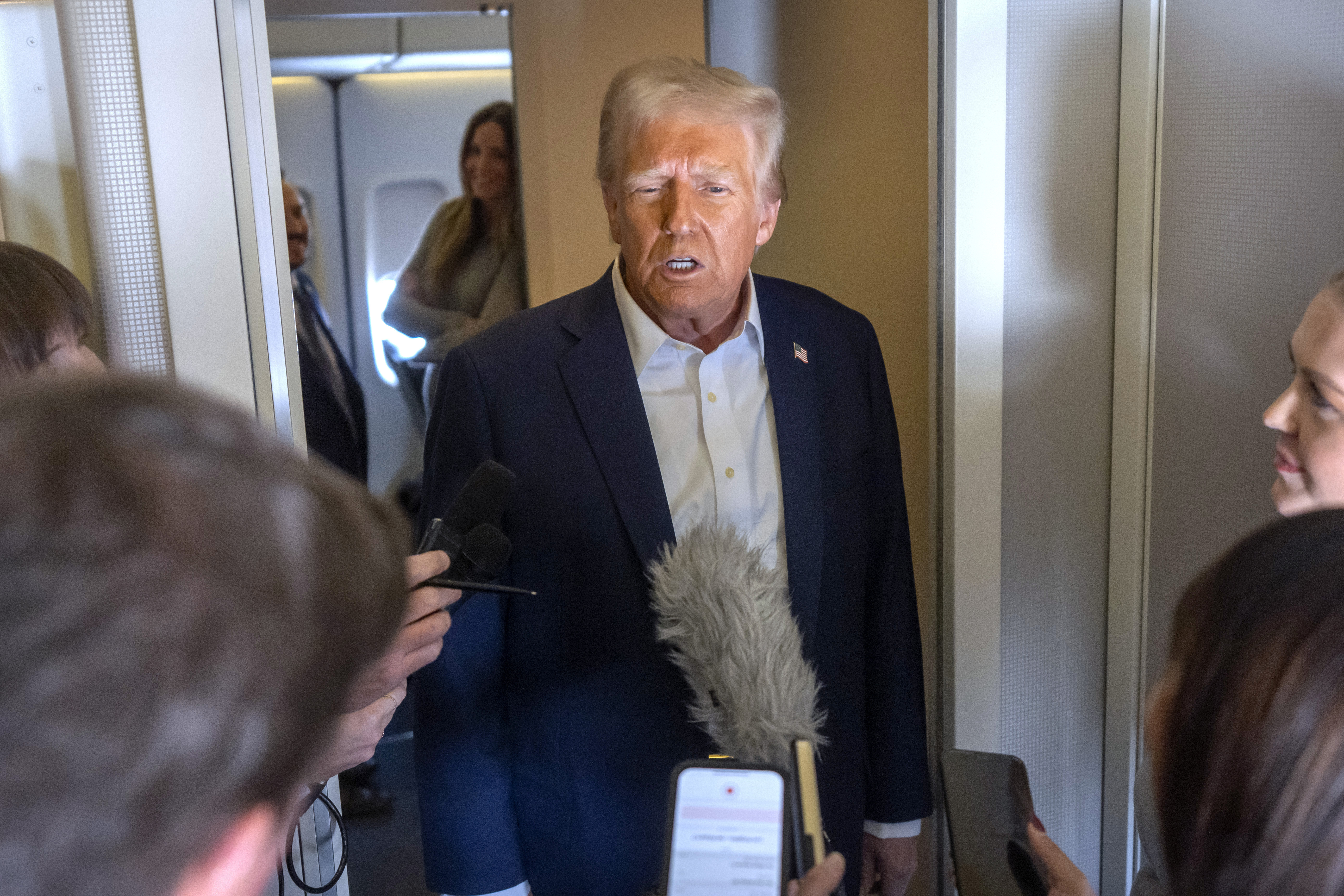 President Donald Trump speaks to reporters aboard Air Force One as he travels from Las Vegas to Miami on Saturday, Jan. 25, 2025. (AP Photo/Mark Schiefelbein)