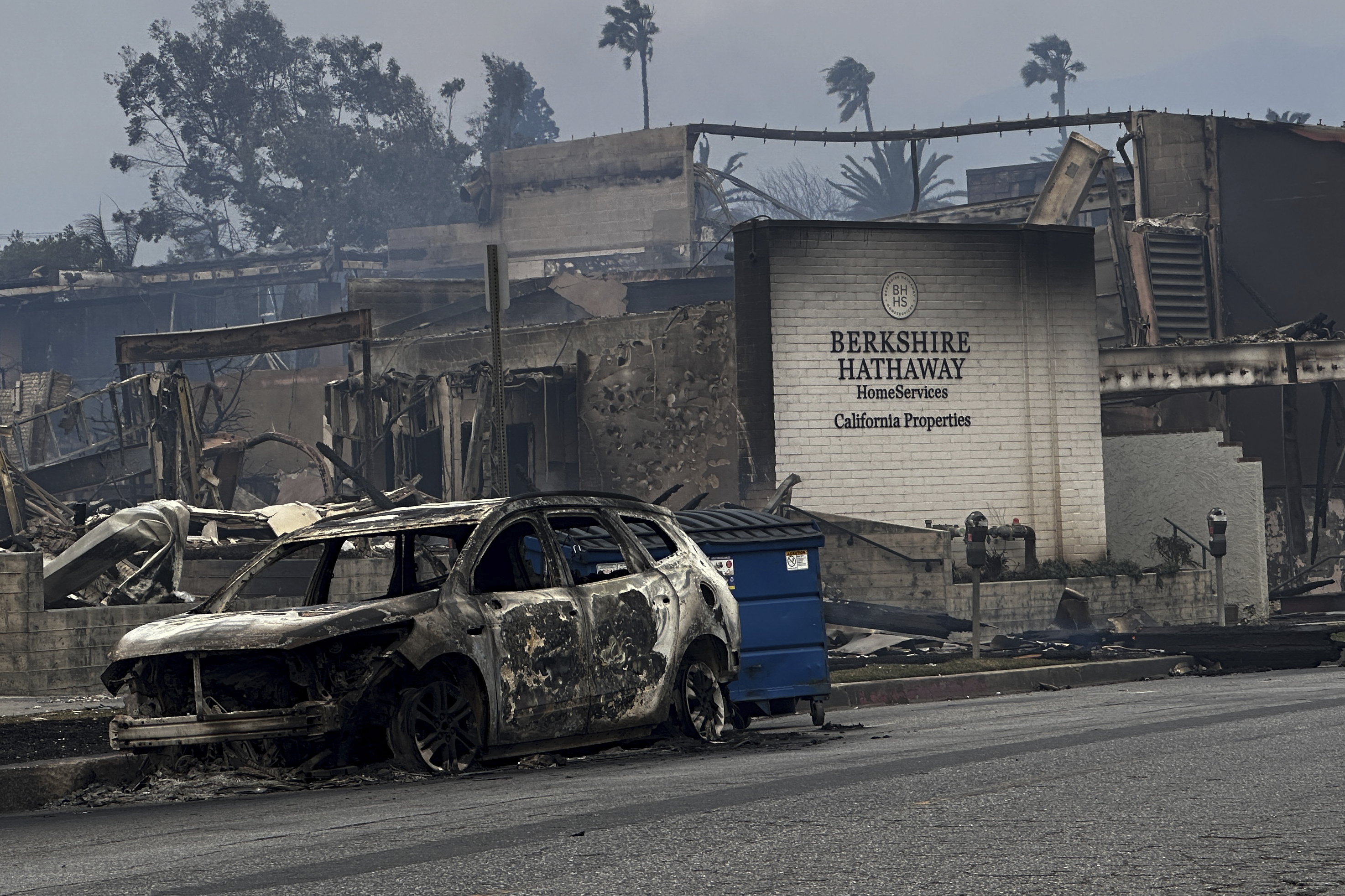 FILE - Fire-ravaged businesses and vehicles are left behind after the Palisades Fire swept through in the Pacific Palisades neighborhood of Los Angeles, Wednesday, Jan. 8, 2025. (AP Photo/Eugene Garcia, File)