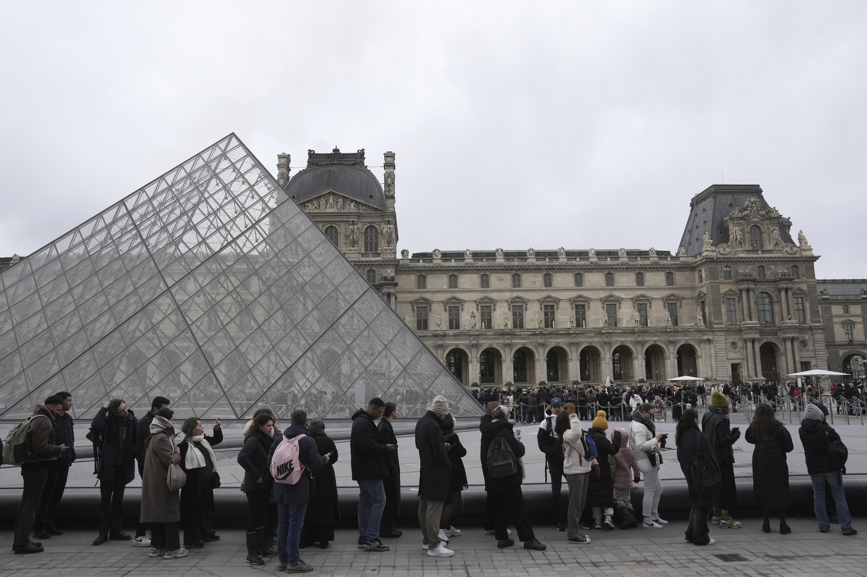 People line up to enter the Louvre museum, Monday, Jan. 27, 2025 in Paris. (AP Photo/Thibault Camus)