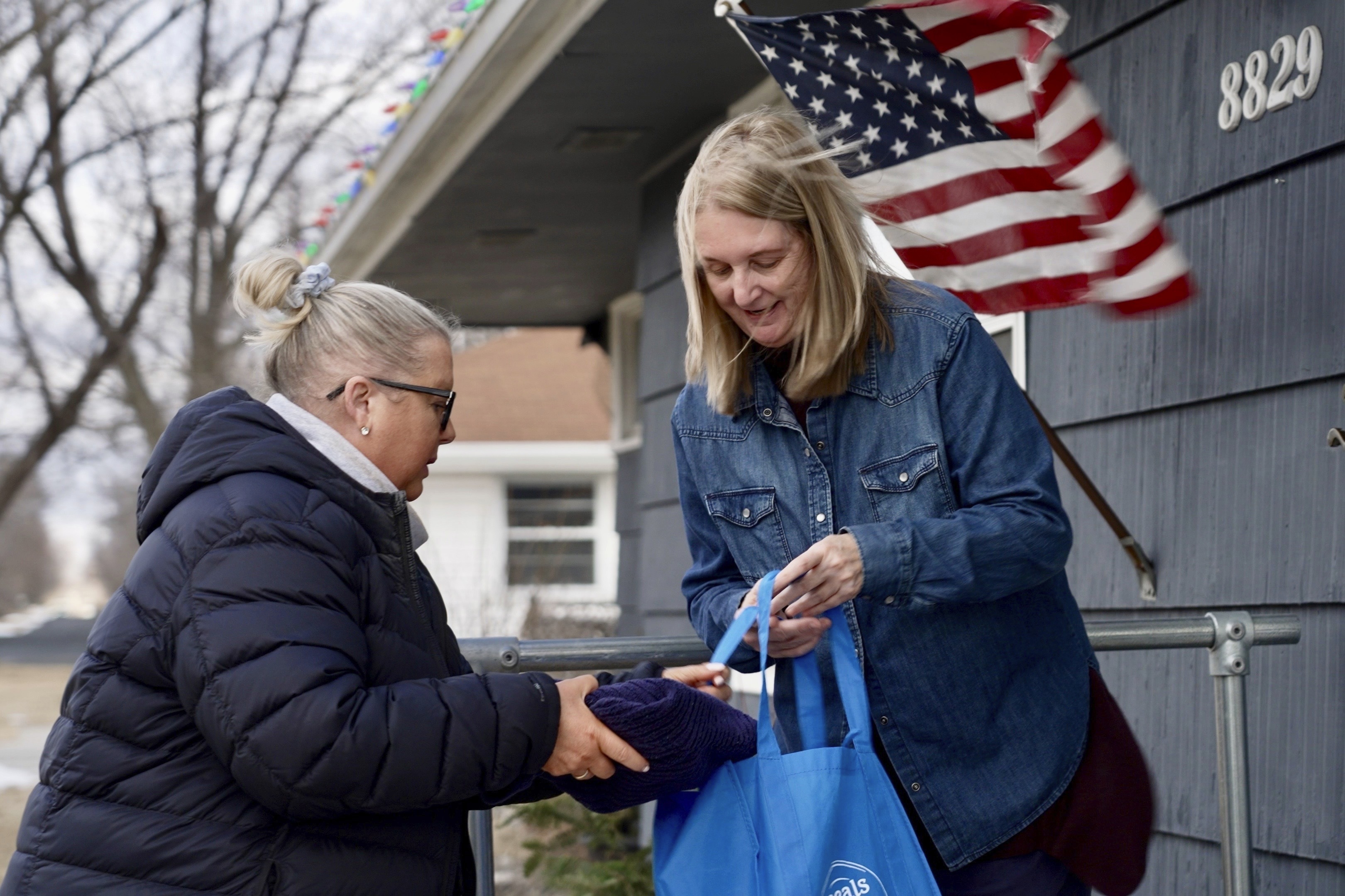 Bloomington and Eden Prairie Meals on Wheels Executive Director Wendy Vossen delivers meals for Barbara Teed and her adult son Ryan, who has Down syndrome, on Wednesday, Jan. 29, 2025, in Bloomington, Minn. (AP photo/Mark Vancleave)