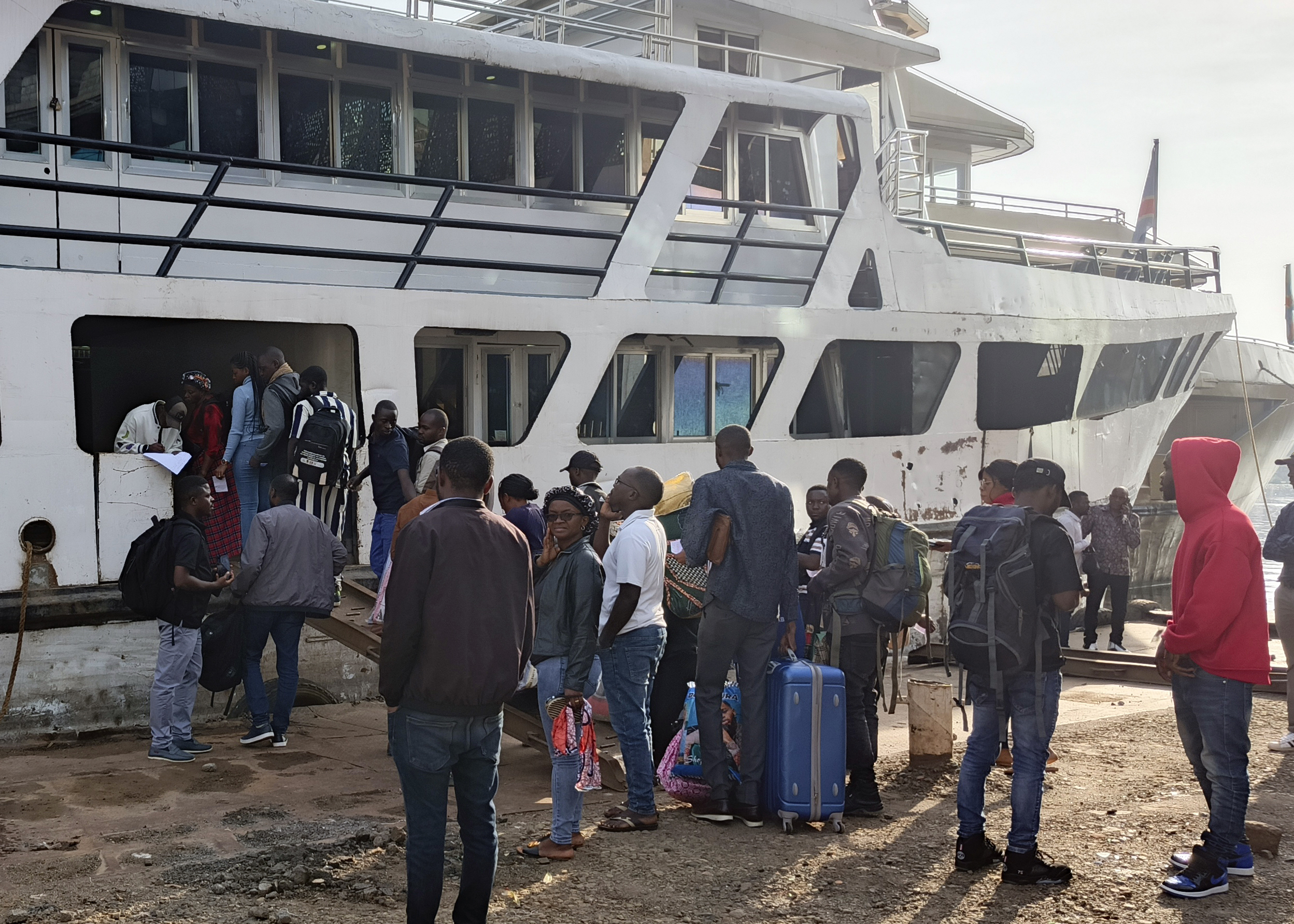 People board the first boat leaving Bukavu heading to Goma on Lake Kivu since the eastern Congo city was taken by M23 rebels Tuesday, Feb. 18, 2025. (AP Photo/Janvier Barhahiga)