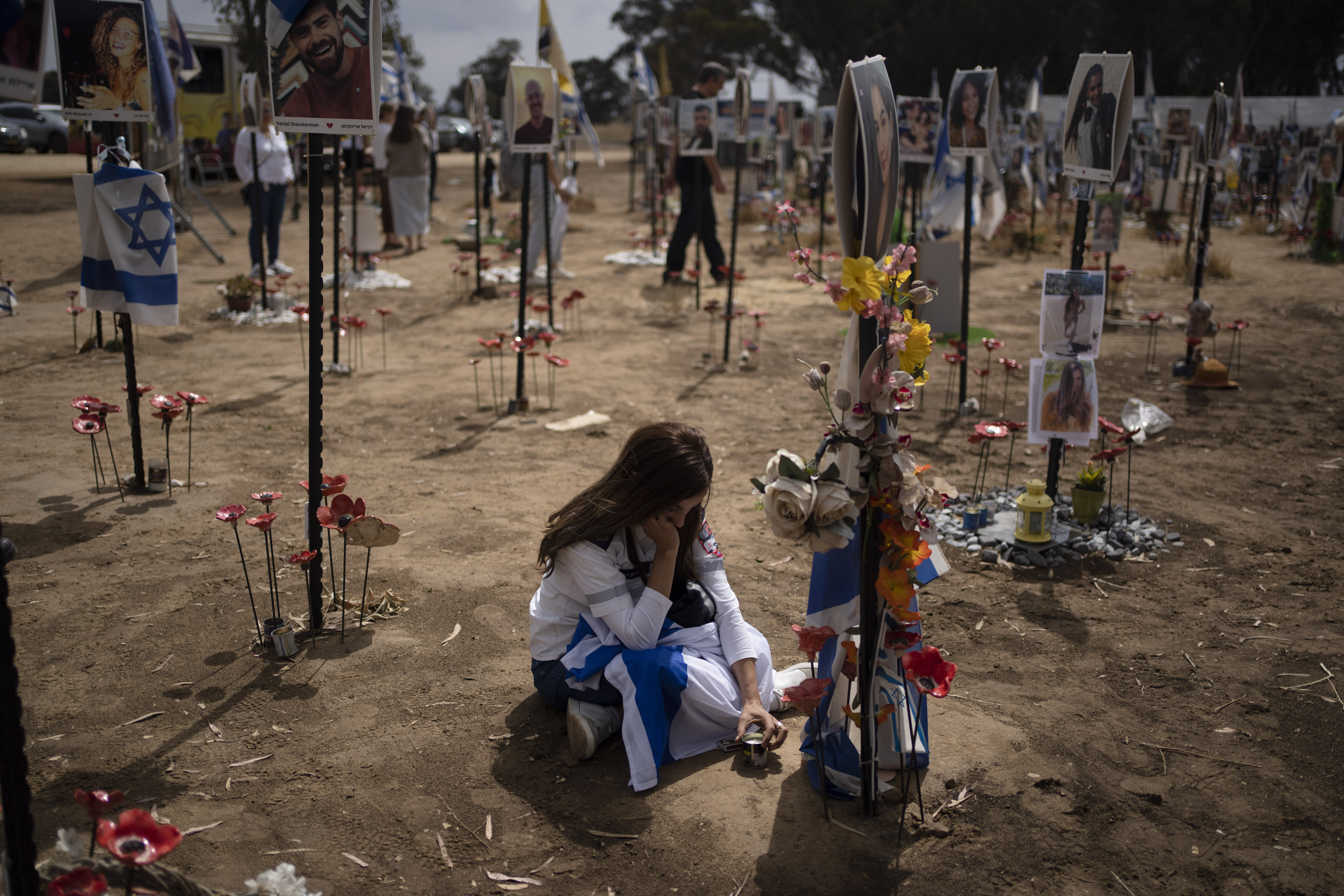 FILE - A woman grieves at a memorial for those killed and abducted during the Oct. 7, 2023, cross-border attack by Hamas militants, near the kibbutz Reim, southern Israel, May 13, 2024. (AP Photo/Leo Correa, File)