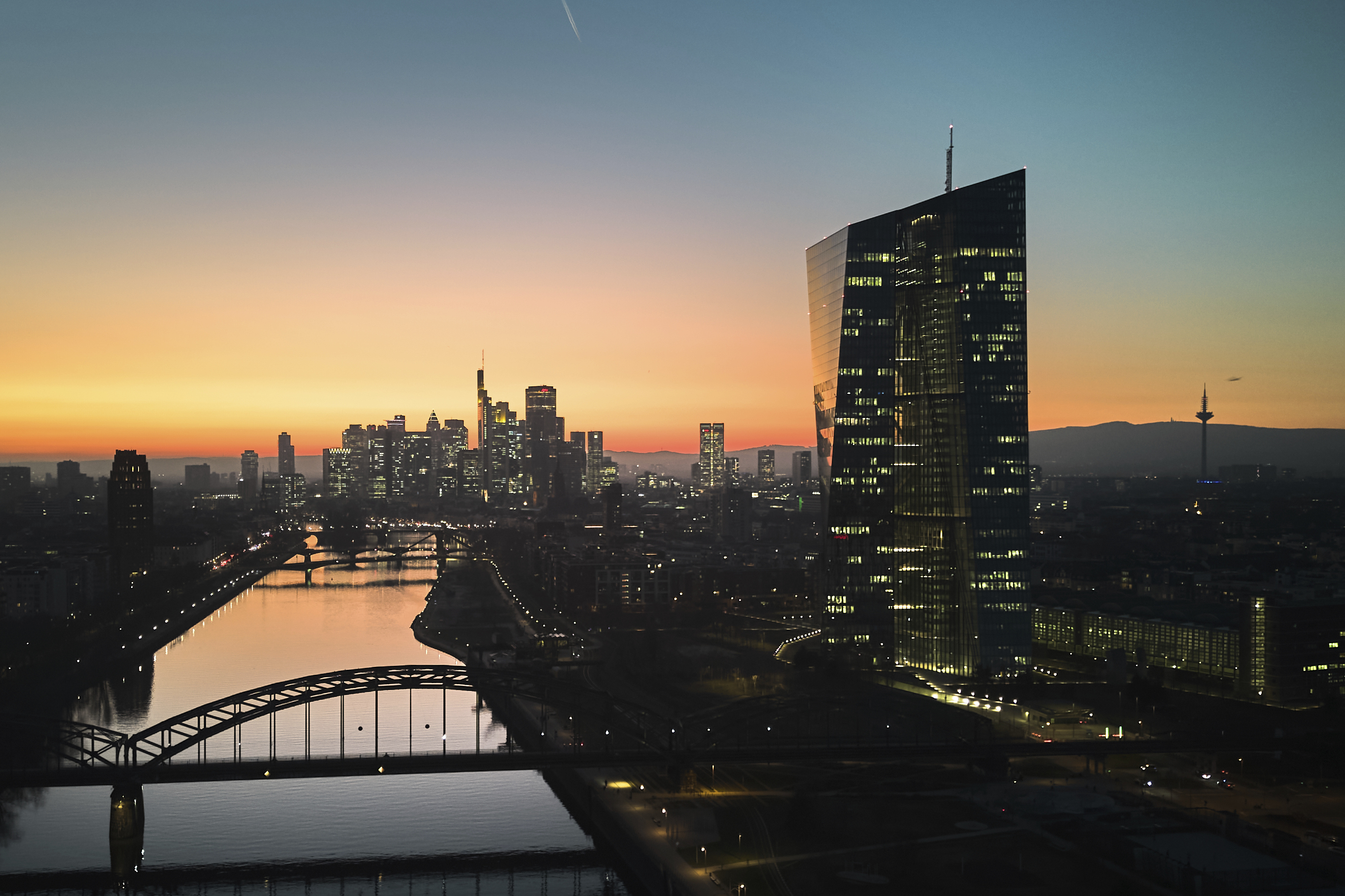 The sun has set behind the European Central Bank, right, in Frankfurt, Germany, Wednesday, March 5, 2025, the day before the meeting of the ECB's governing council. (AP Photo/Michael Probst)