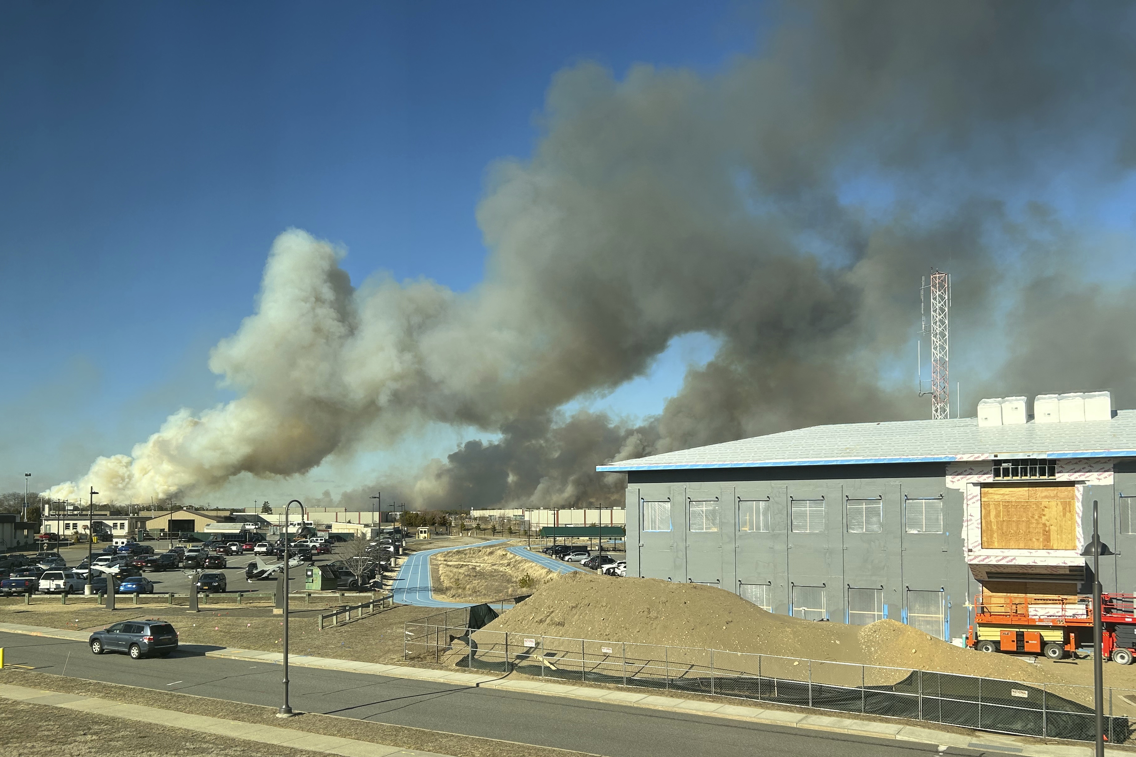 This photo provided by the New York Air National Guard shows smoke from the fires in the Pine Barrens off Sunrise Highway in New York's Long Island, on Saturday, March 8, 2025. (Cheran Campbell/New York Air National Guard via AP)