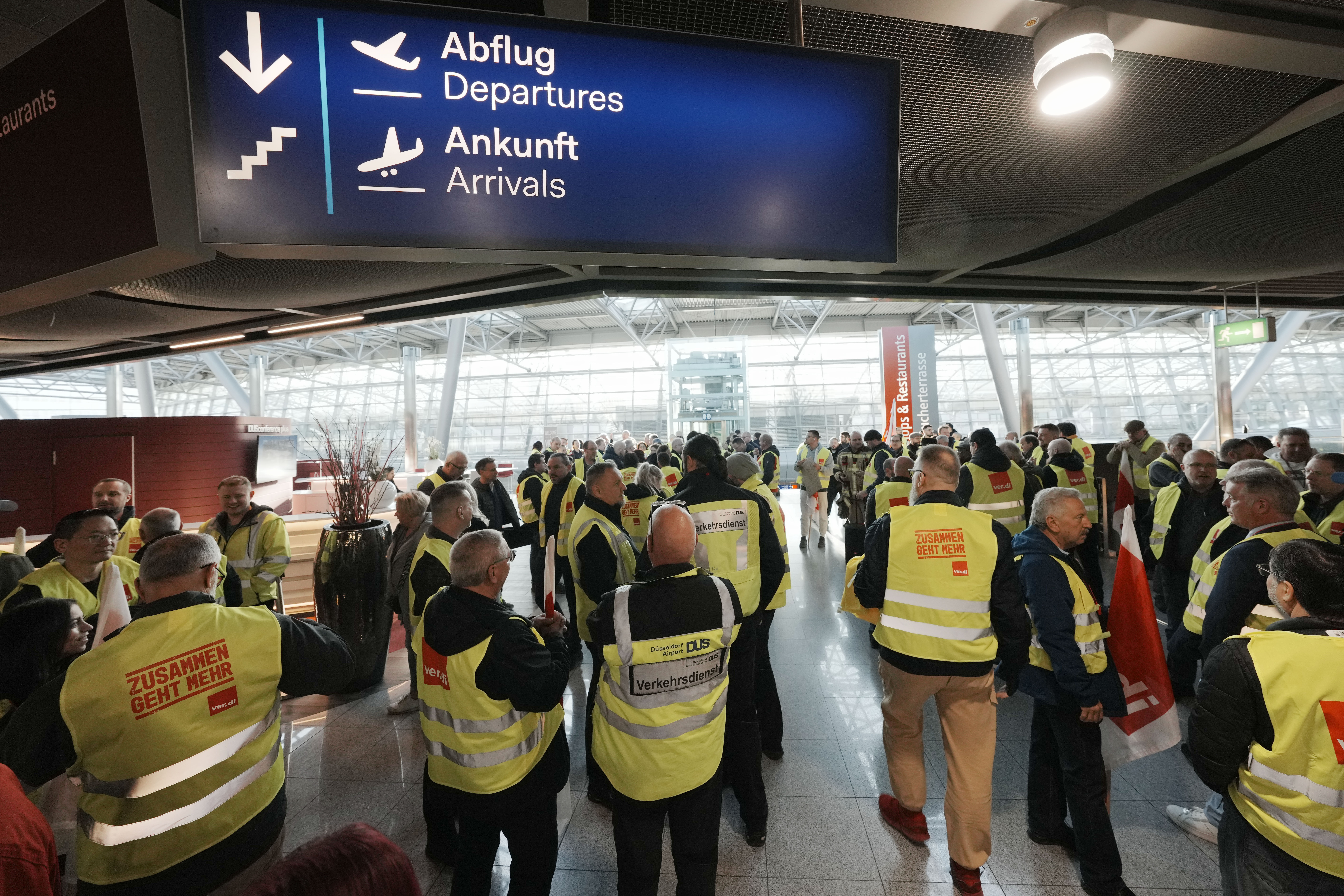 Airport workers protest during a strike of the union ver.di at the airport in Duesseldorf, Germany on Monday, March 10, 2025, when all major airports in Germany went on a warning strike. (AP Photo/Martin Meissner)