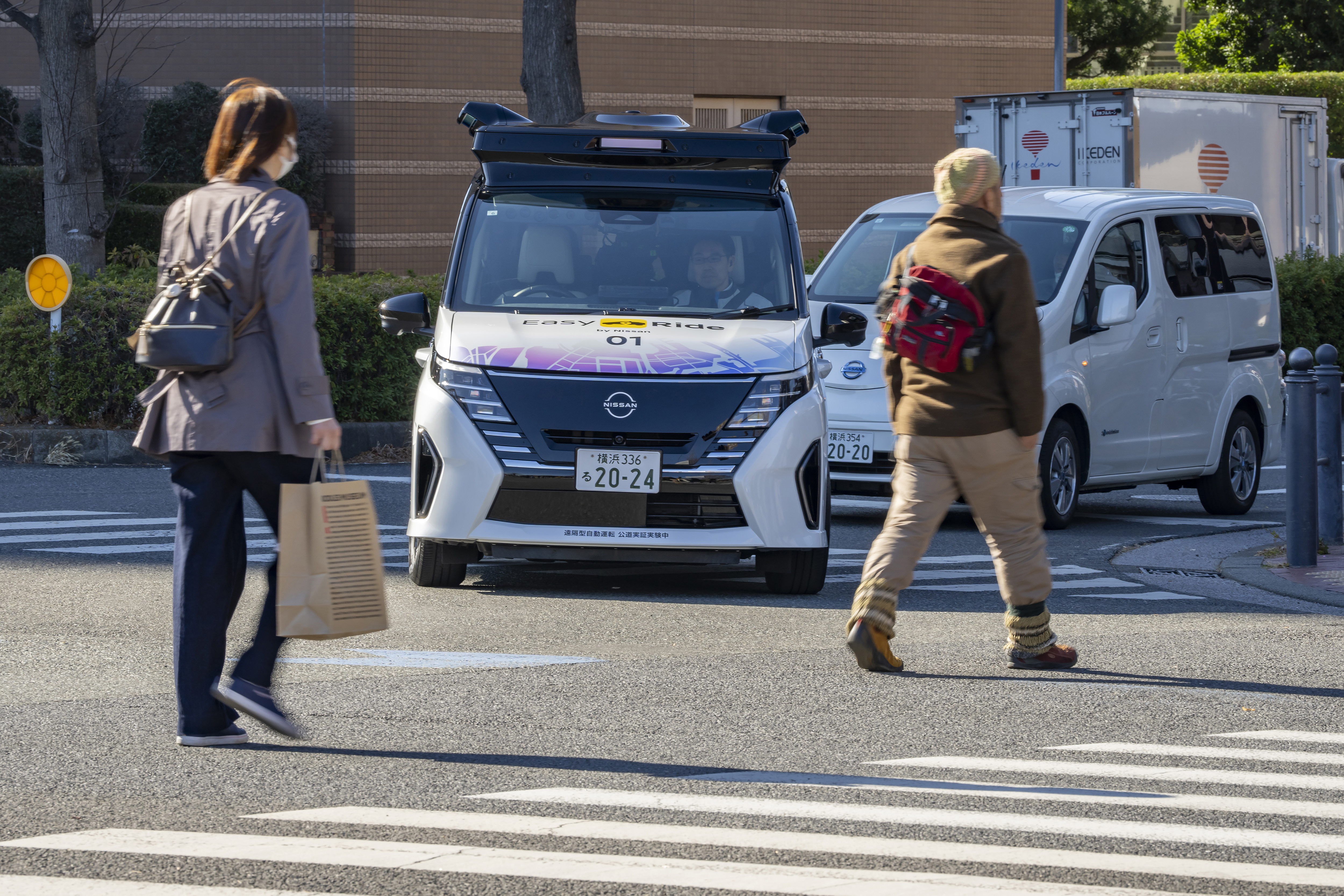 In this photo released by Nissan Motor Corp., its driverless vehicle, center, drives along a street in Yokohama, near Tokyo in February 2025. (Nissan Motor Corp. via AP)