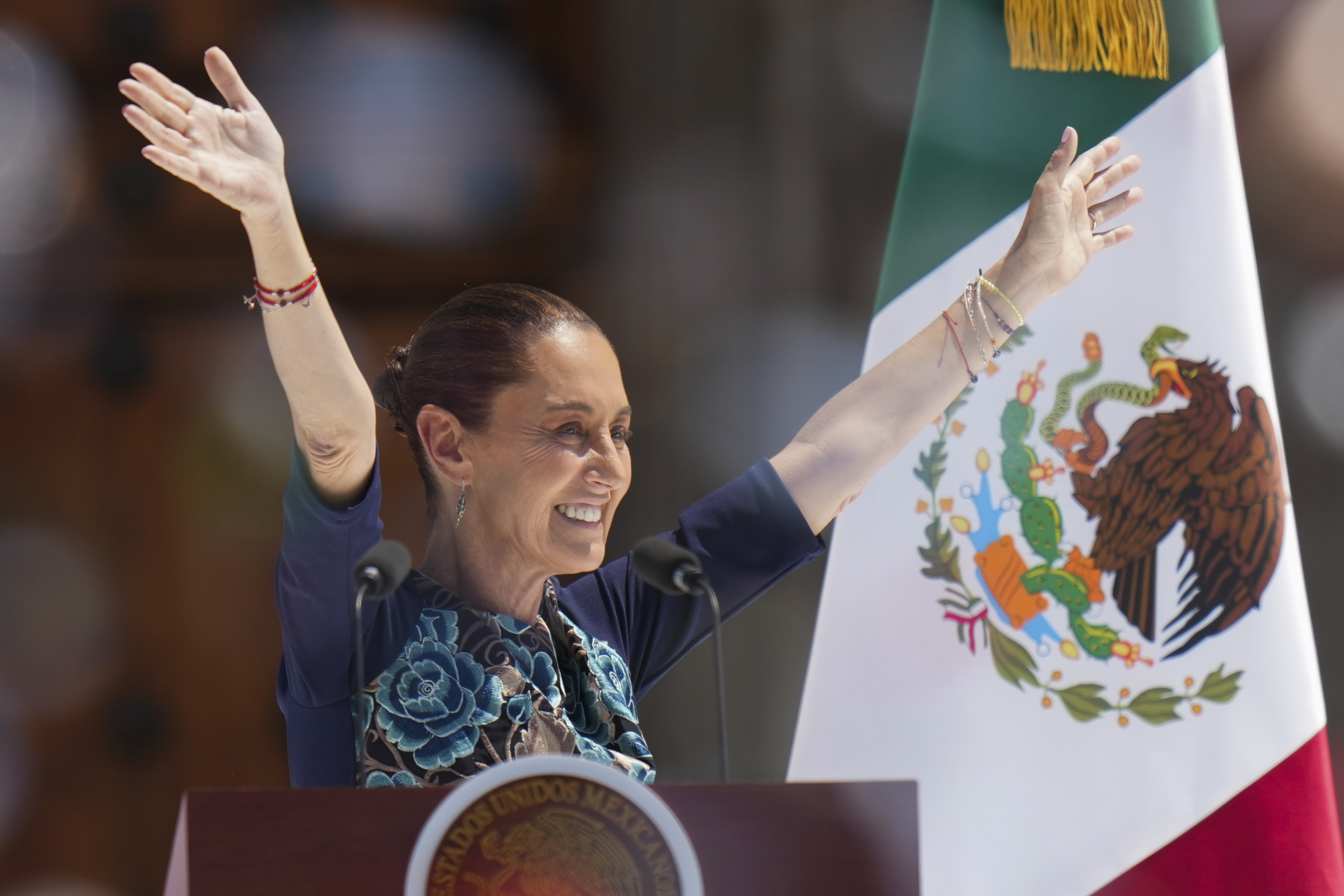 President Claudia Sheinbaum waves to supporters at a rally she convened to welcome U.S. President Donald Trump's decision to postpone tariffs on Mexican goods for one month at the Zocalo, Mexico City's main square, Sunday, March 9, 2025. (AP Photo/Eduardo Verdugo)